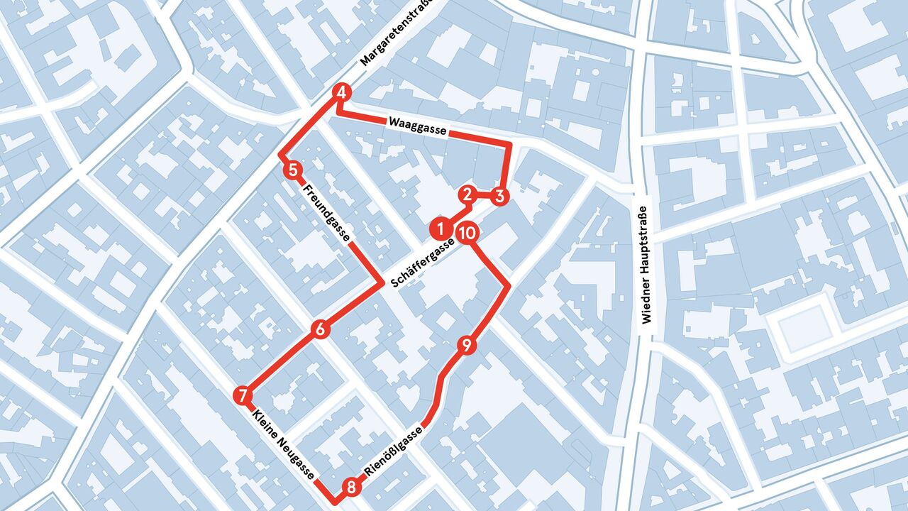 Stadtplan mit blau-grauen Gebäuden und roter Linie, die eine Rundroute mit nummerierten Stationen markiert