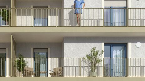 Zu sehen ist eine Visualisierung des Wohnprojekts mit heller Fassade.