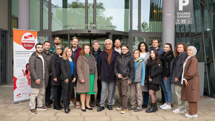Gruppenbild der Abschlussklasse des wohnpartner Lehrgangs vor der Volkhochschule