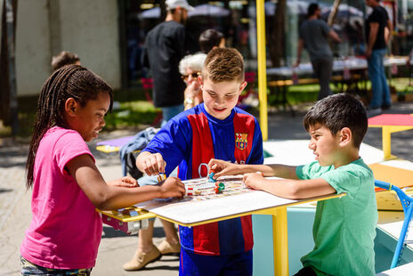 Kinder spielen ein Brettspiel.