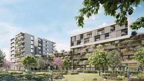 mehrstöckige moderne Wohngebäude mit begrünten Fassaden und Gartenanlage im Vordergrund unter blauem Himmel