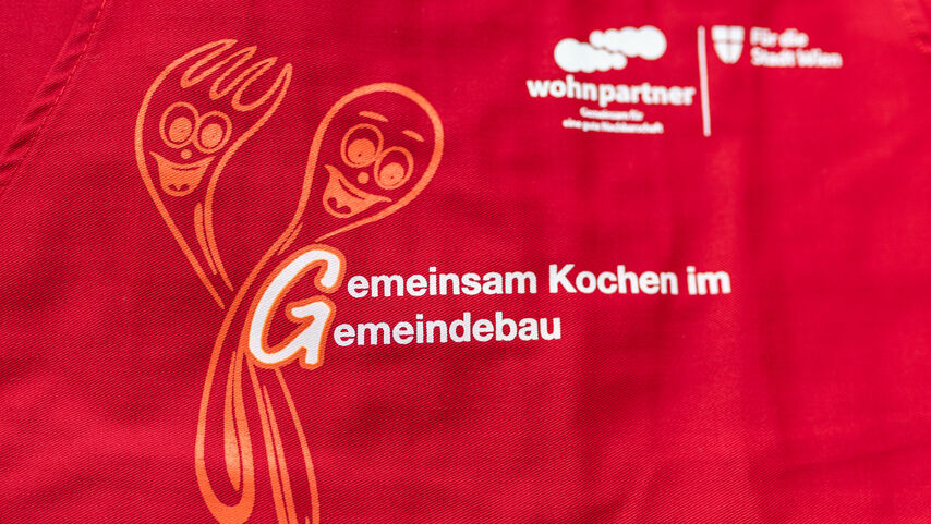 Imagebild einer Schürze mit dem Spruch Gemeinsam Kochen im Gemeindebau