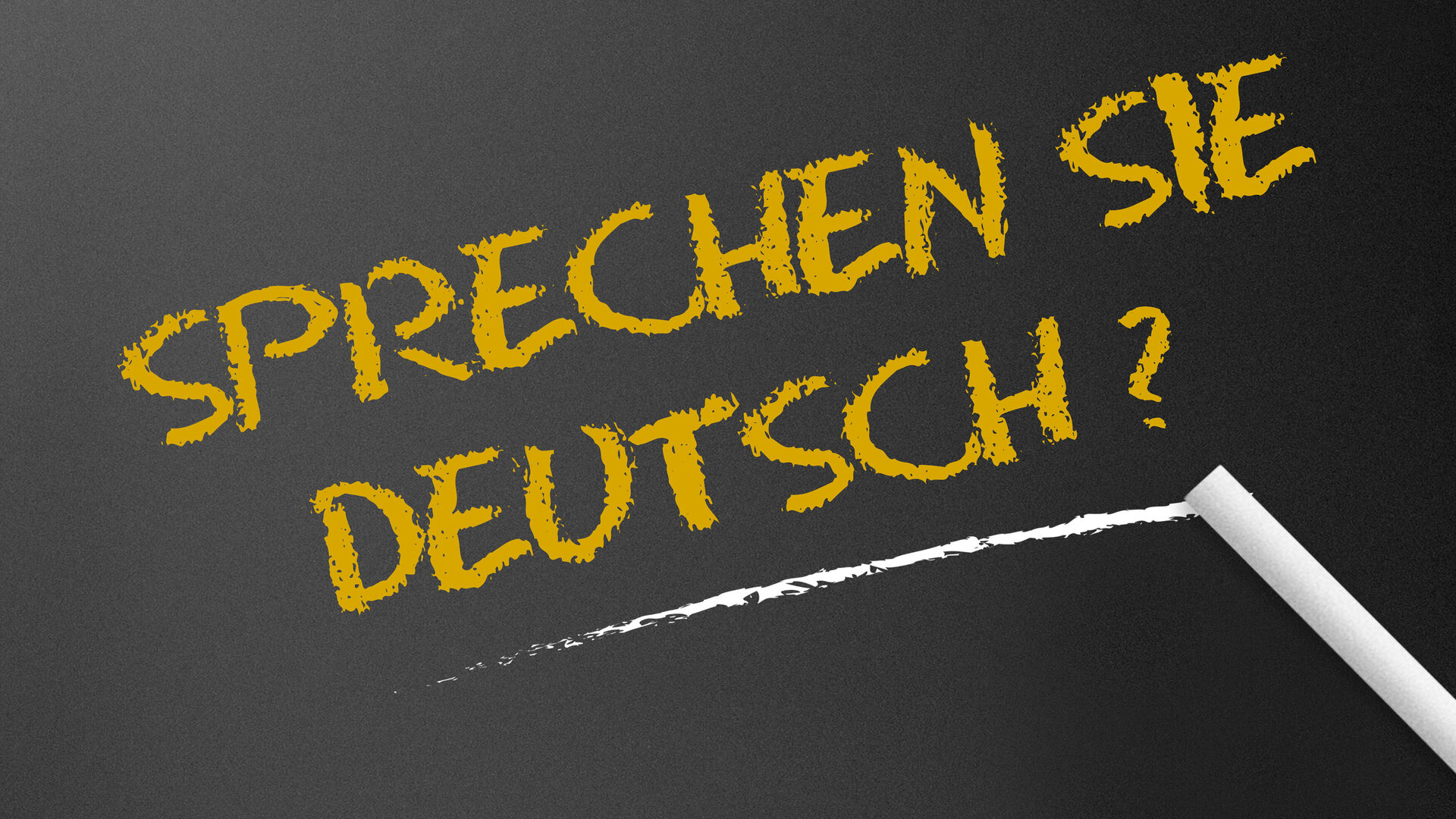 Schriftzug "Sprechen Sie deutsch?" auf einer Tafel, mit Kreide geschrieben